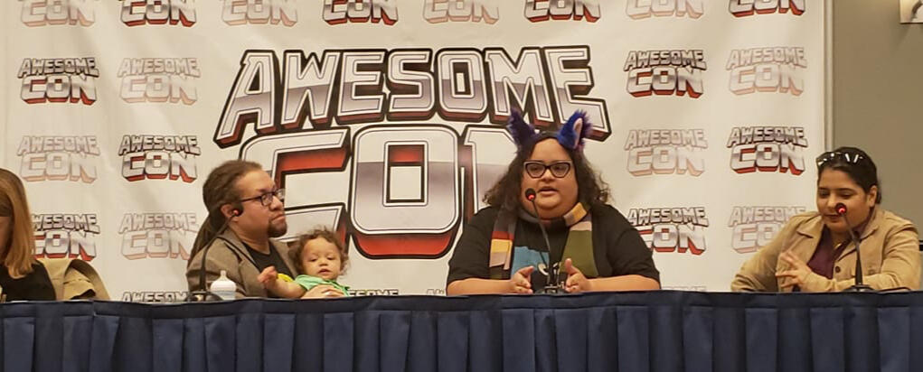 Patrick seated at a broadcast‑style desk with lights and microphones at the White House